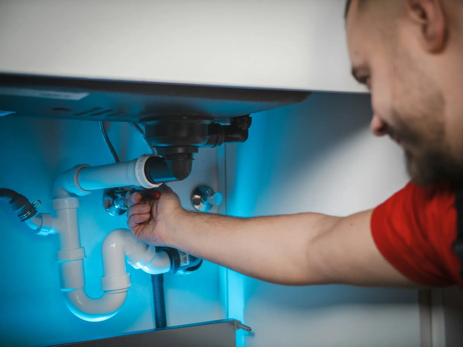 Plumber fixing a sink